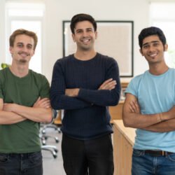 best support team of french language course in delhi smiling with three people folding hands and smiling